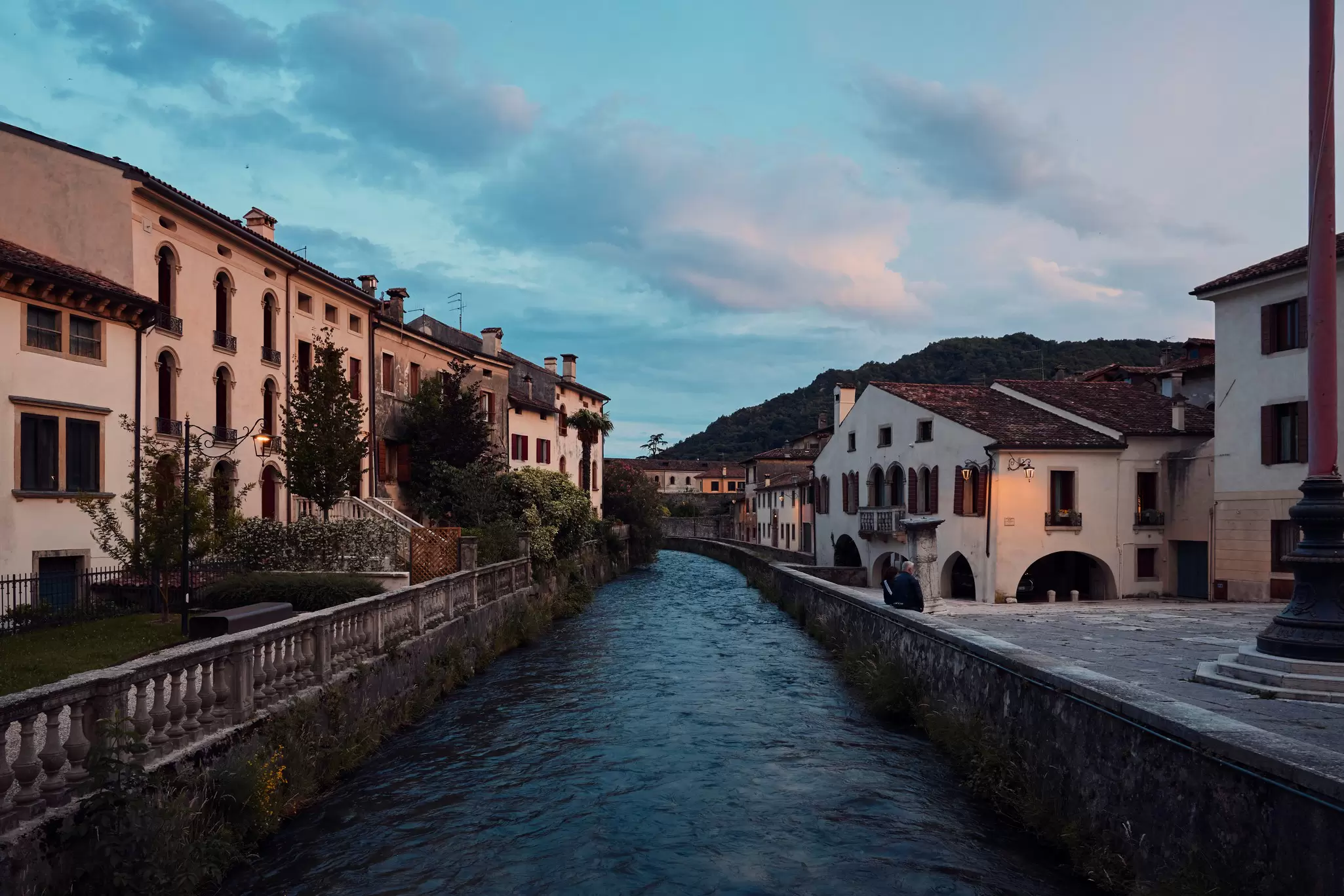 Large, old houses lining a canal at dusk