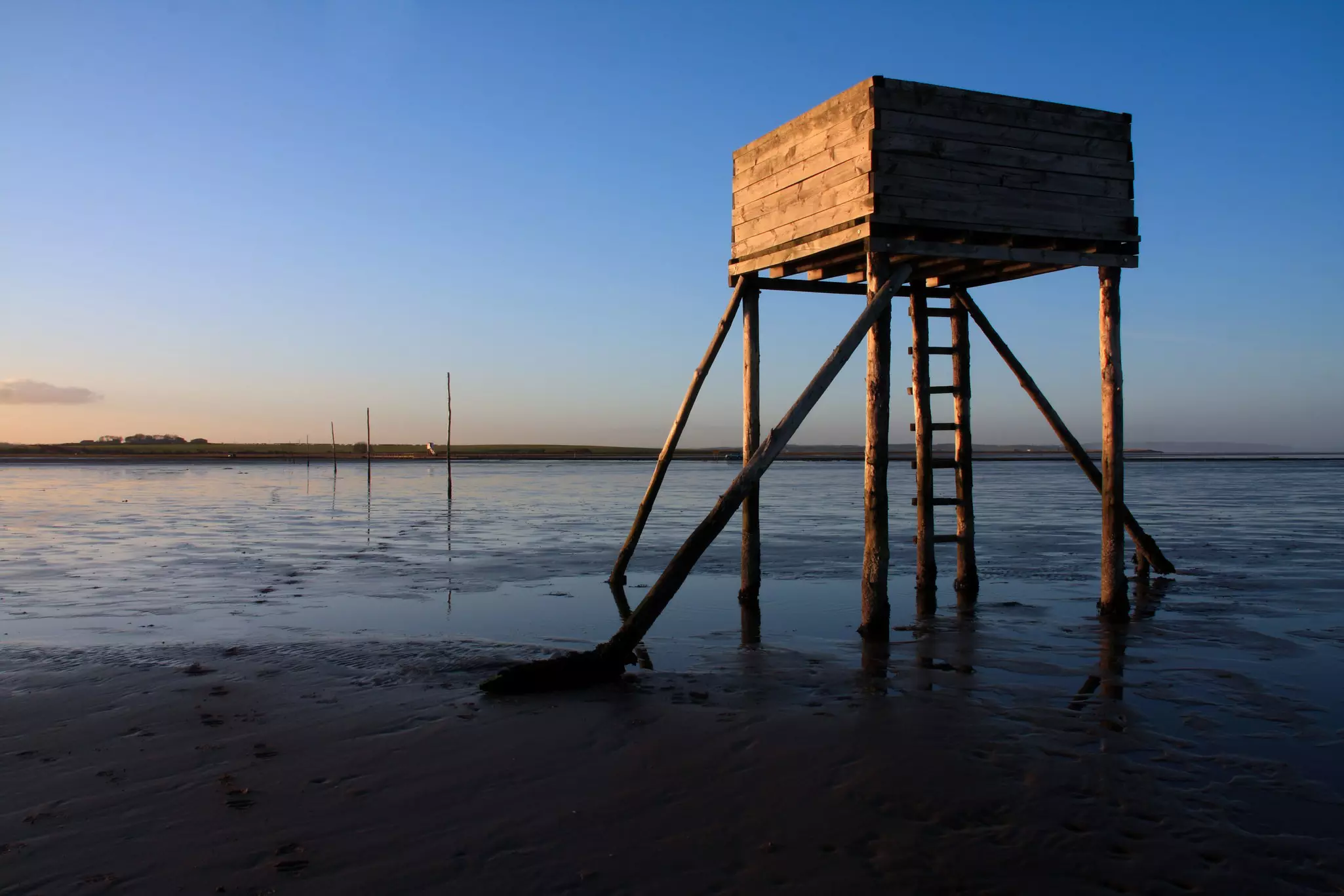 A wooden structure on stilts above a tidal causeway, to provide shelter to any walkers on the Pilgrim's Way to Lindisfarne (Holy Island), England.