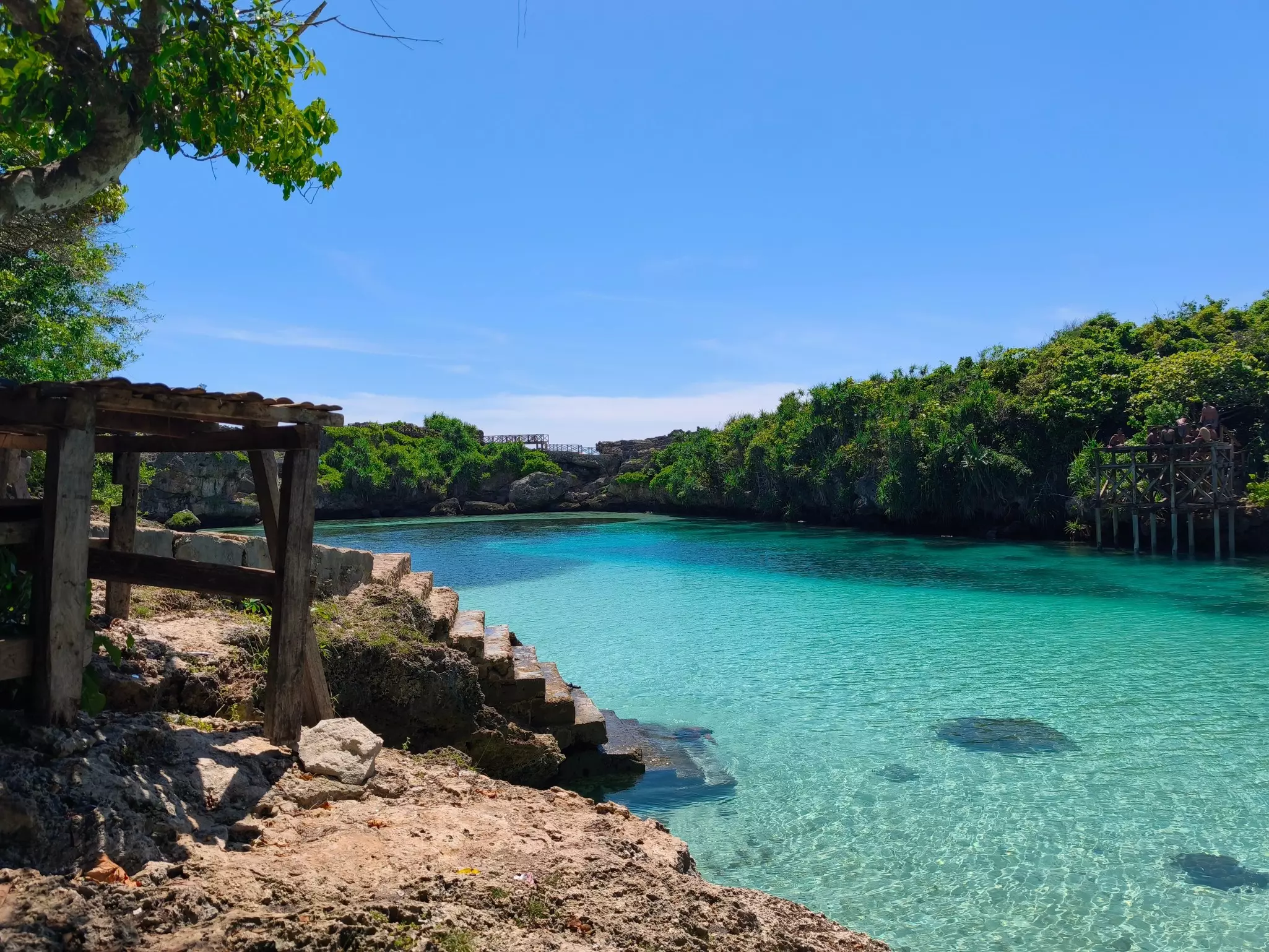 Stone steps lead to a shallow turquoise lagoon.