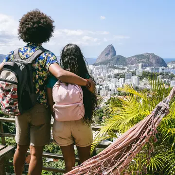 A couple with backpacks overlook Rio de Janiero, Brazil. 