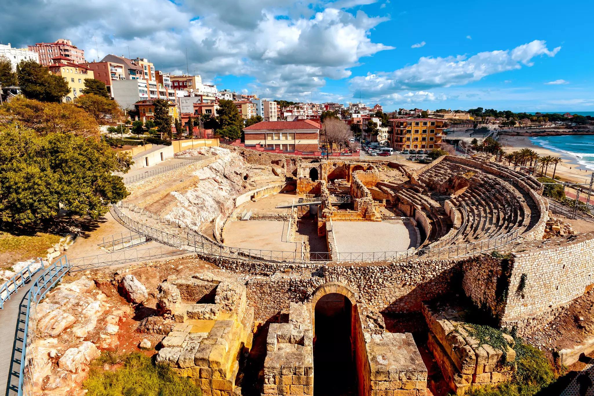 A panoramic view of the ancient Roman amphitheater of Tarragona, Spain, next to the Mediterranean sea