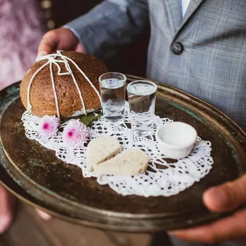 Wedding tradition in Poland and Russia. Parents welcome bride and groom with bread, vodka and salt. Decorative tray with food and alcohol. Empty copy space european culture background., License Type: media, Download Time: 2025-12-09T22:12:31.000Z, User: Norma.PrauseBrewer_LonelyPlanet, Editorial: false, purchase_order: 56530 - Guidebooks, job: Global Publishing WIP, client: Europe 5, other: Norma Brewer