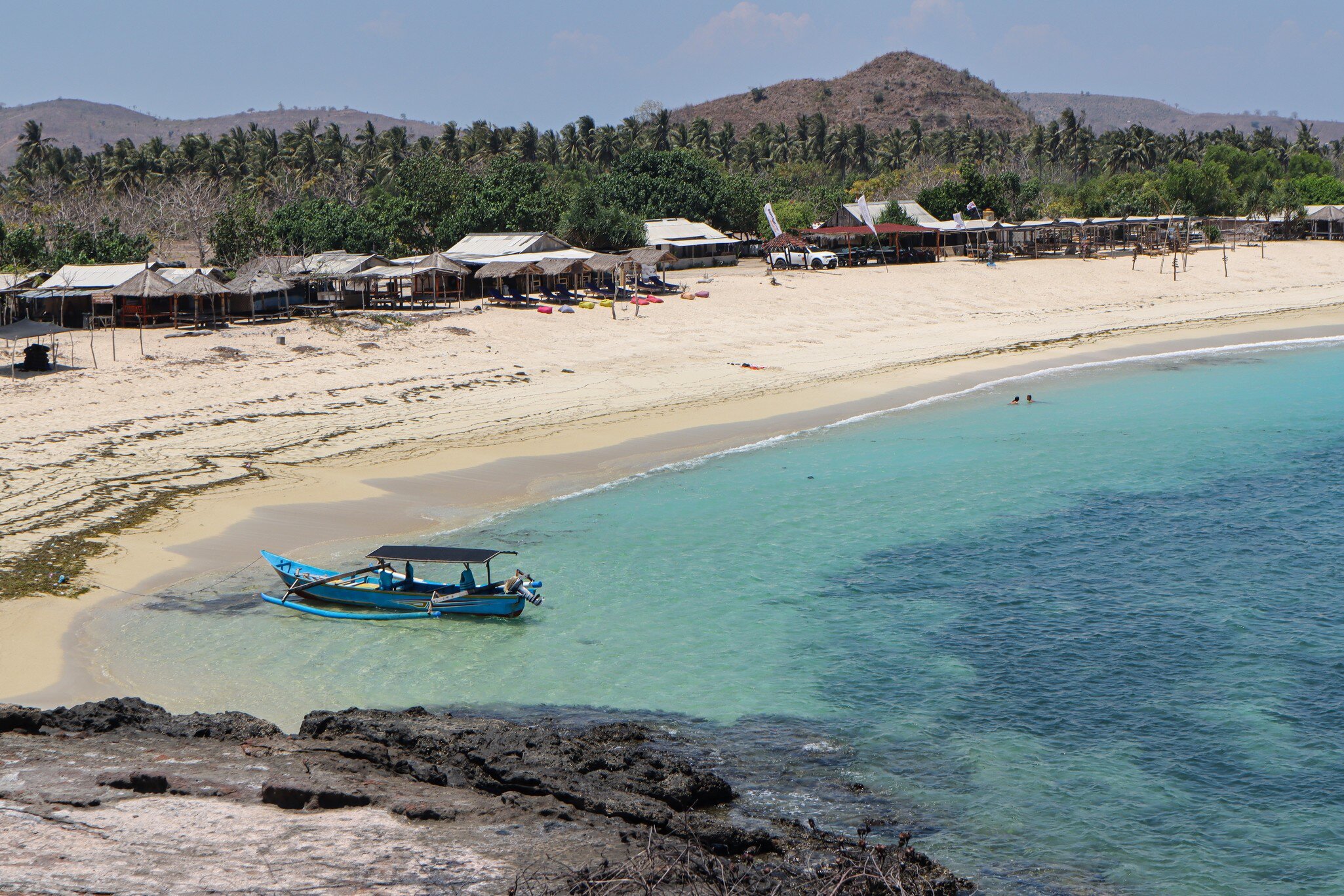 A blue boat in Tanjung Aan Beach, Lombok Island, Indonesia.