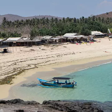 A blue boat in Tanjung Aan Beach, Lombok Island, Indonesia.