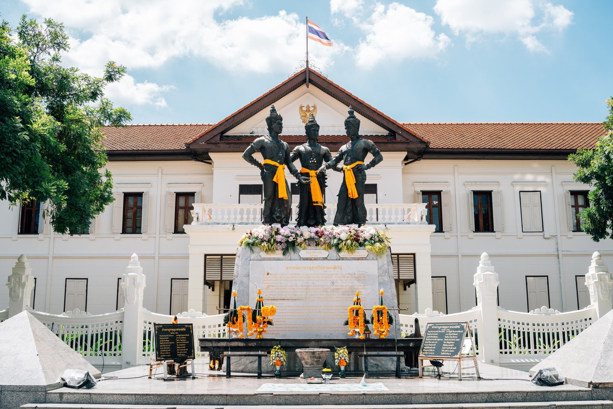 Exterior of Three Kings Monument and Chiang Mai City Arts & Cultural Centre in Chiang Mai, Thailand. Blue sky.