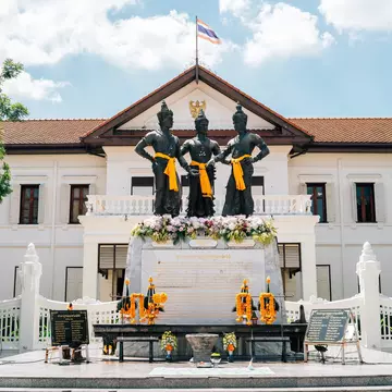 Exterior of Three Kings Monument and Chiang Mai City Arts & Cultural Centre in Chiang Mai, Thailand. Blue sky.