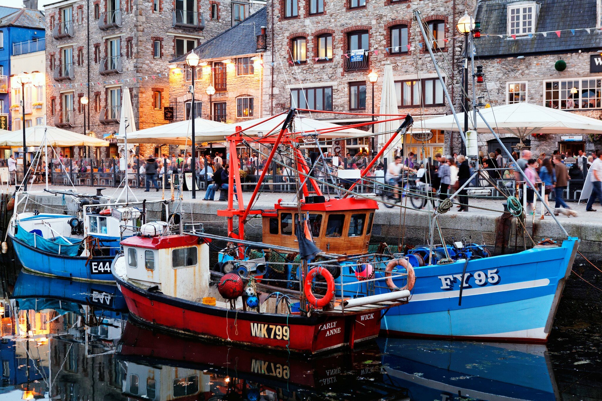 Fishing vessels and terraces of Pubs and restaurants, Barbican, Old harbour, Plymouth, Devon - stock photo
