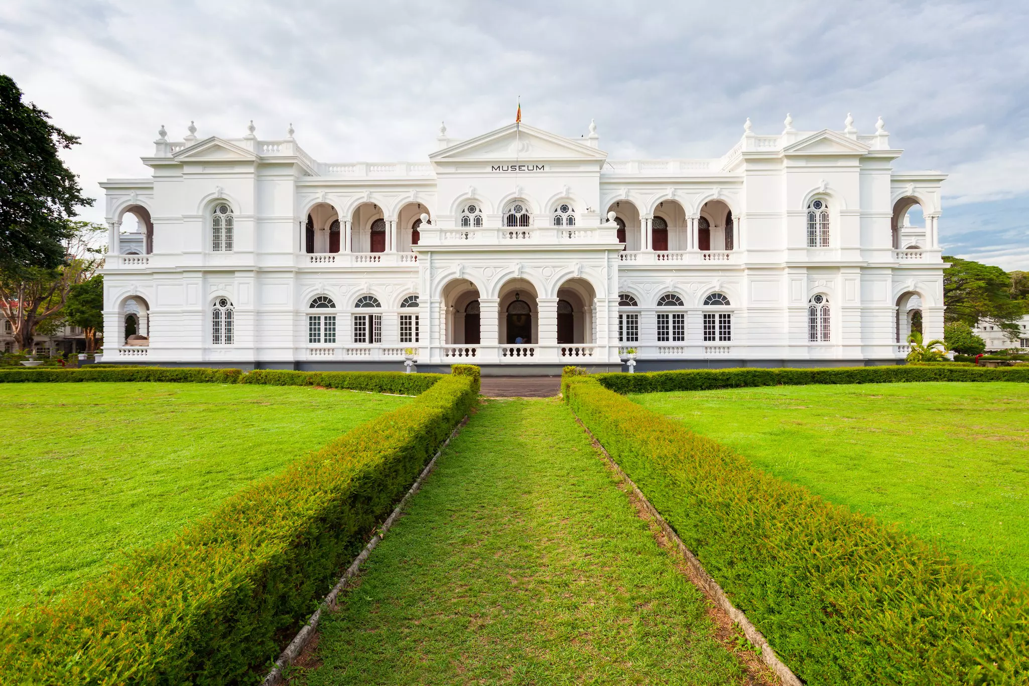 A large white museum building with green grounds.
