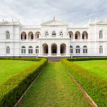 A large white museum building with green grounds.