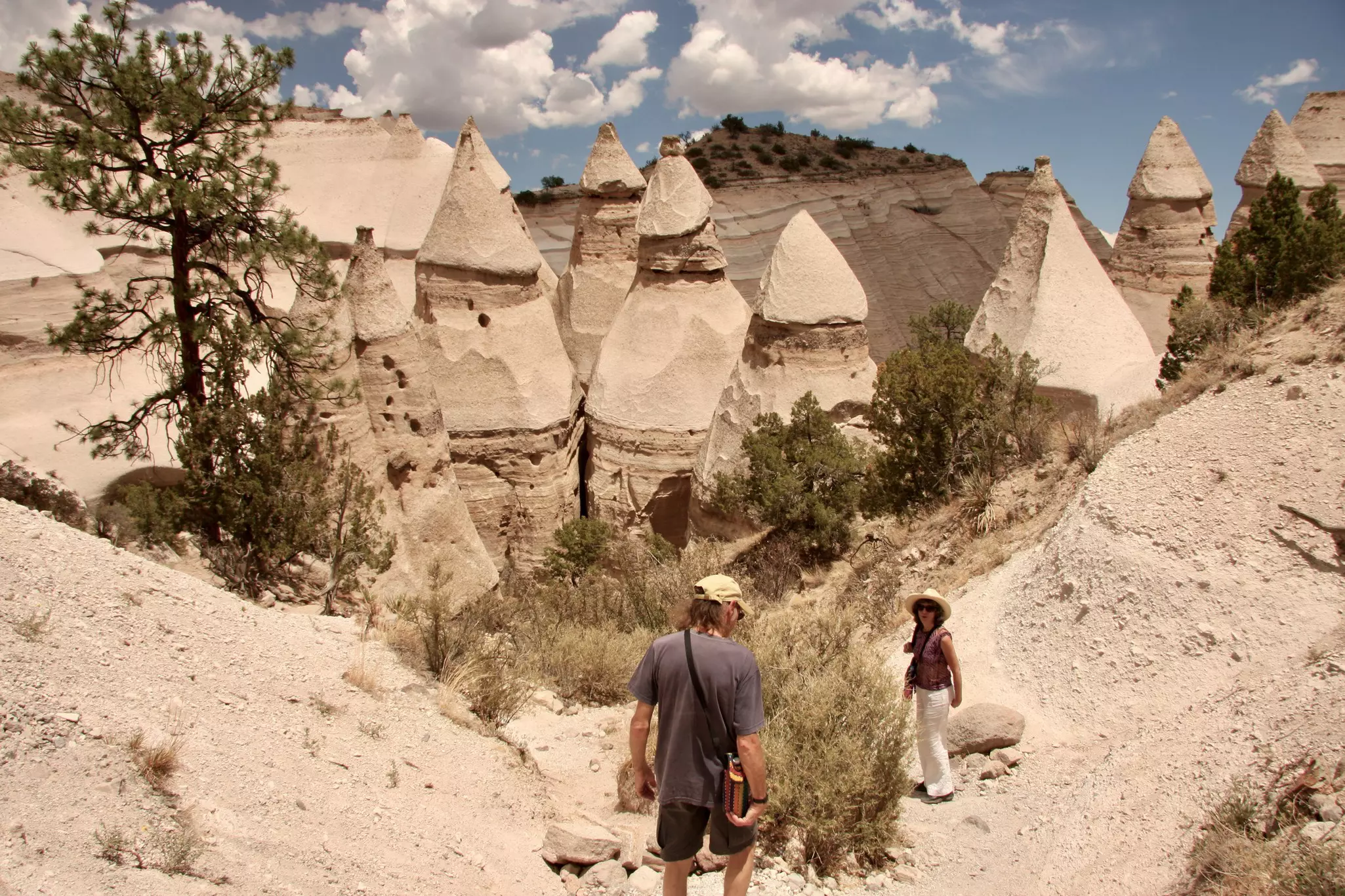 Two people hiking at Kasha-Katuwe National Monument
