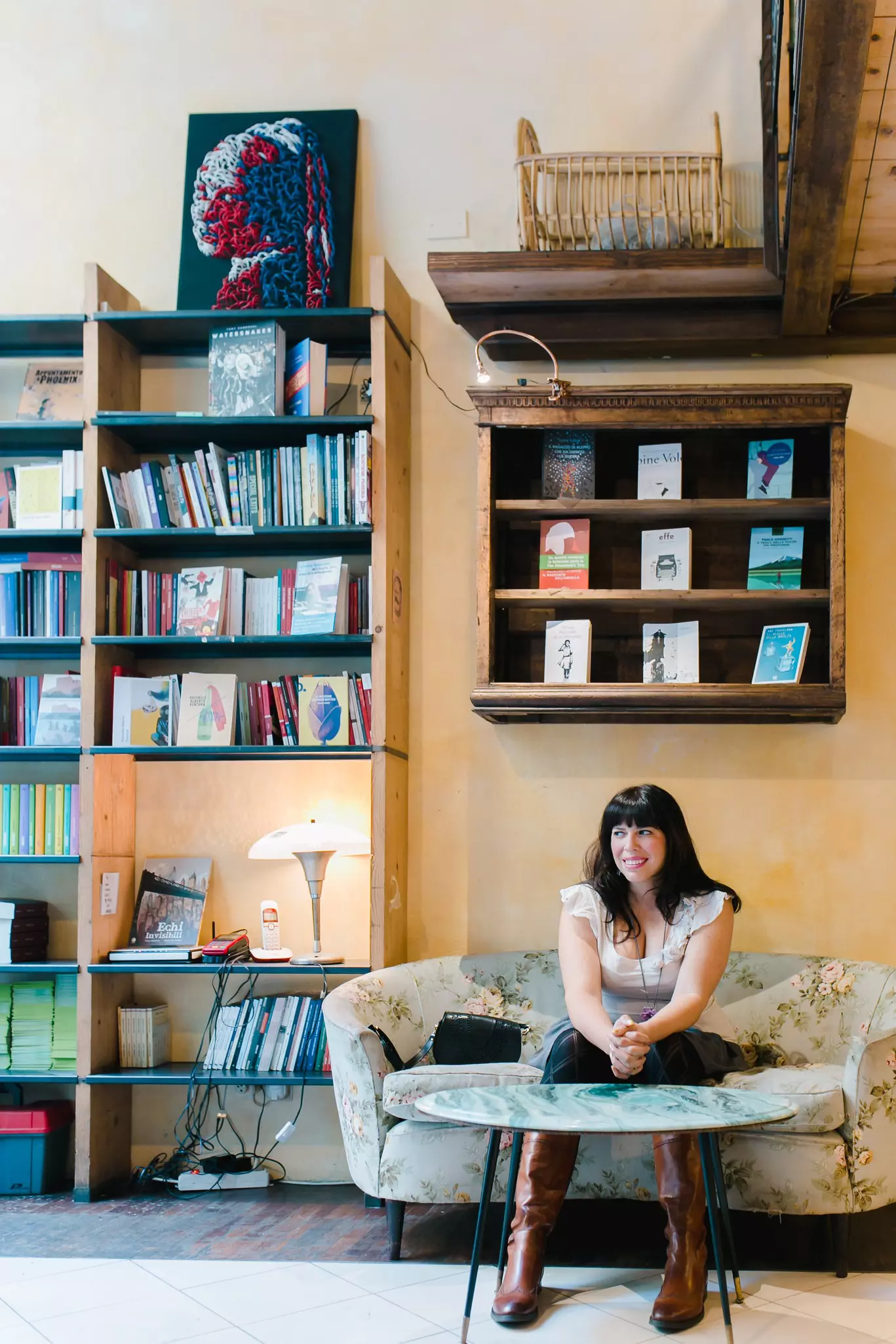 A woman smiling inside a bookshop