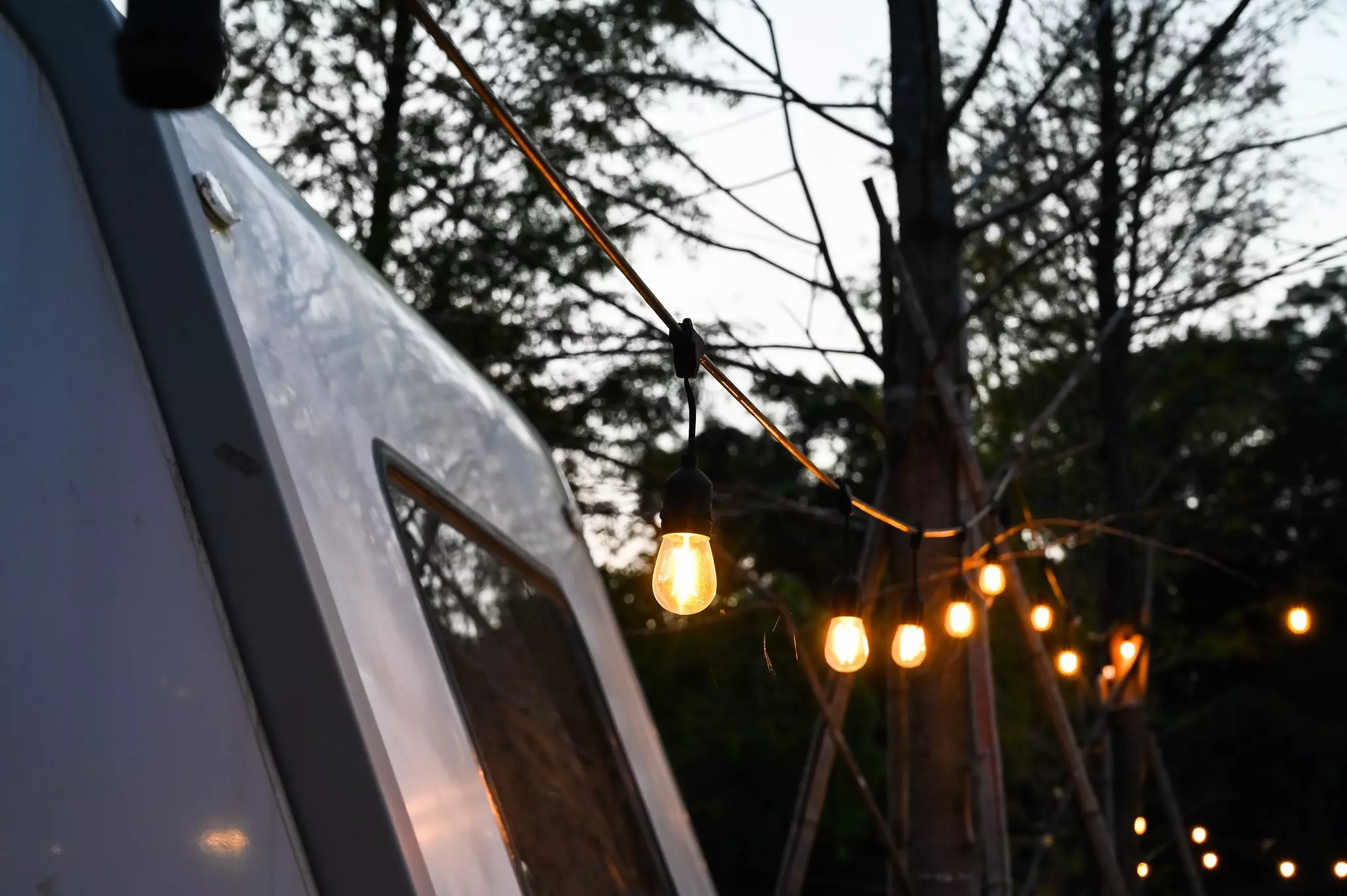 Close shot of hanging lights at a campground 