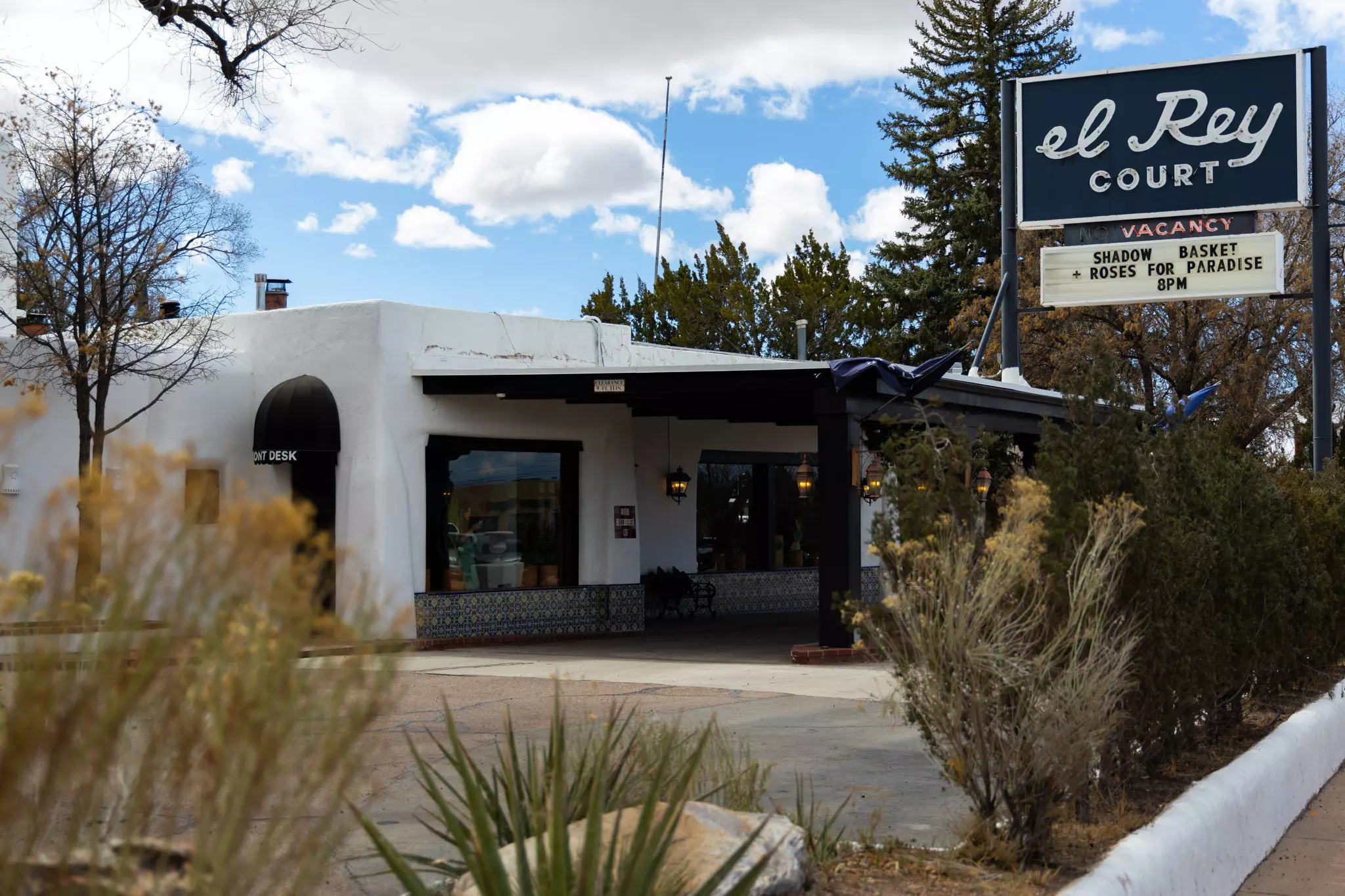 El Rey Court motel in Santa Fe with trees and shrubs all around