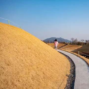 A young girl runs along a pathway in Suncheon Bay National Garden, South Korea.