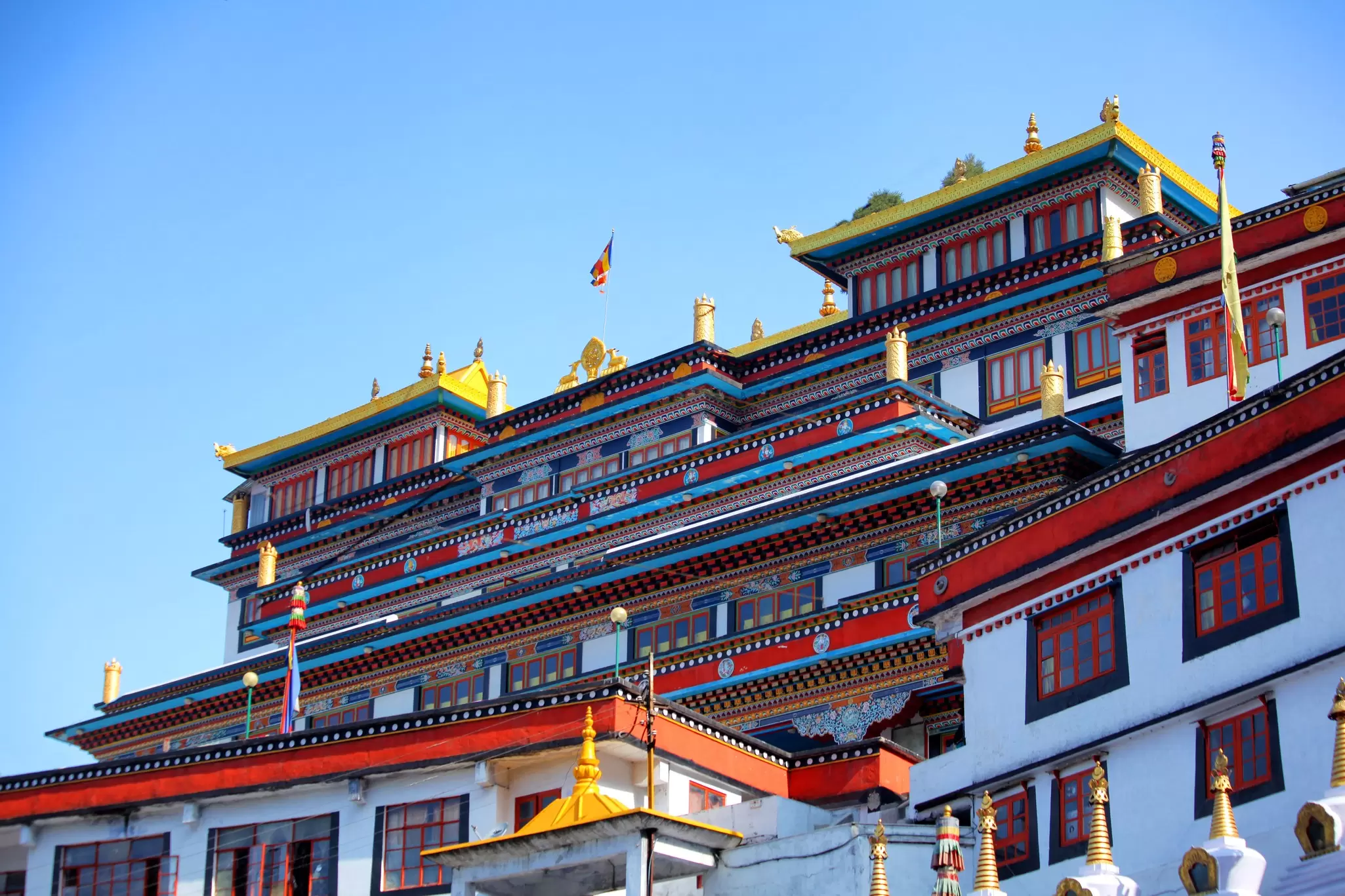 A colorful Tibetan Buddhist monastery in Darjeeling, India viewed from the ground looking up