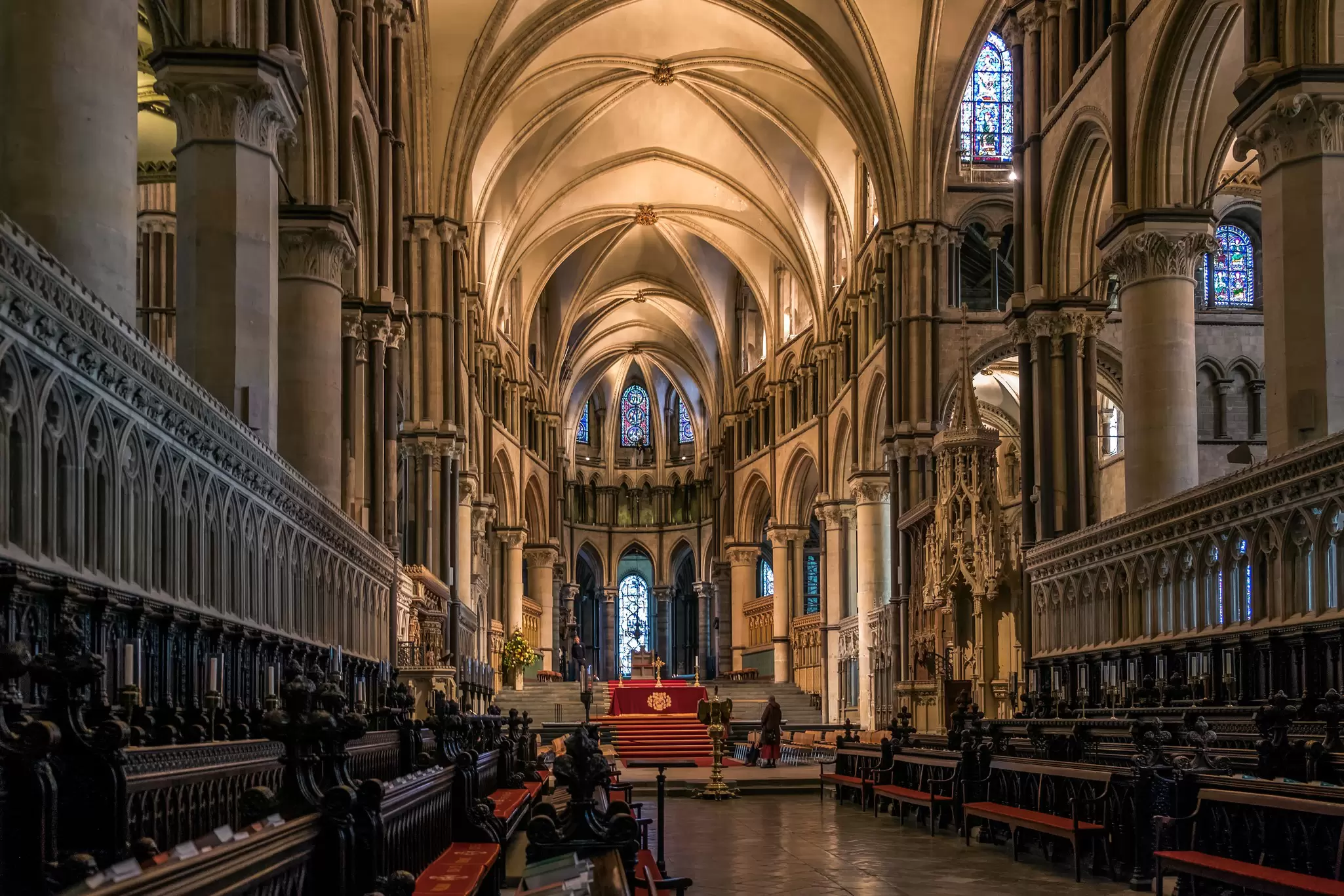 The vaulted stone interior of Canterbury Cathedral looking east towards the quire and stained glass