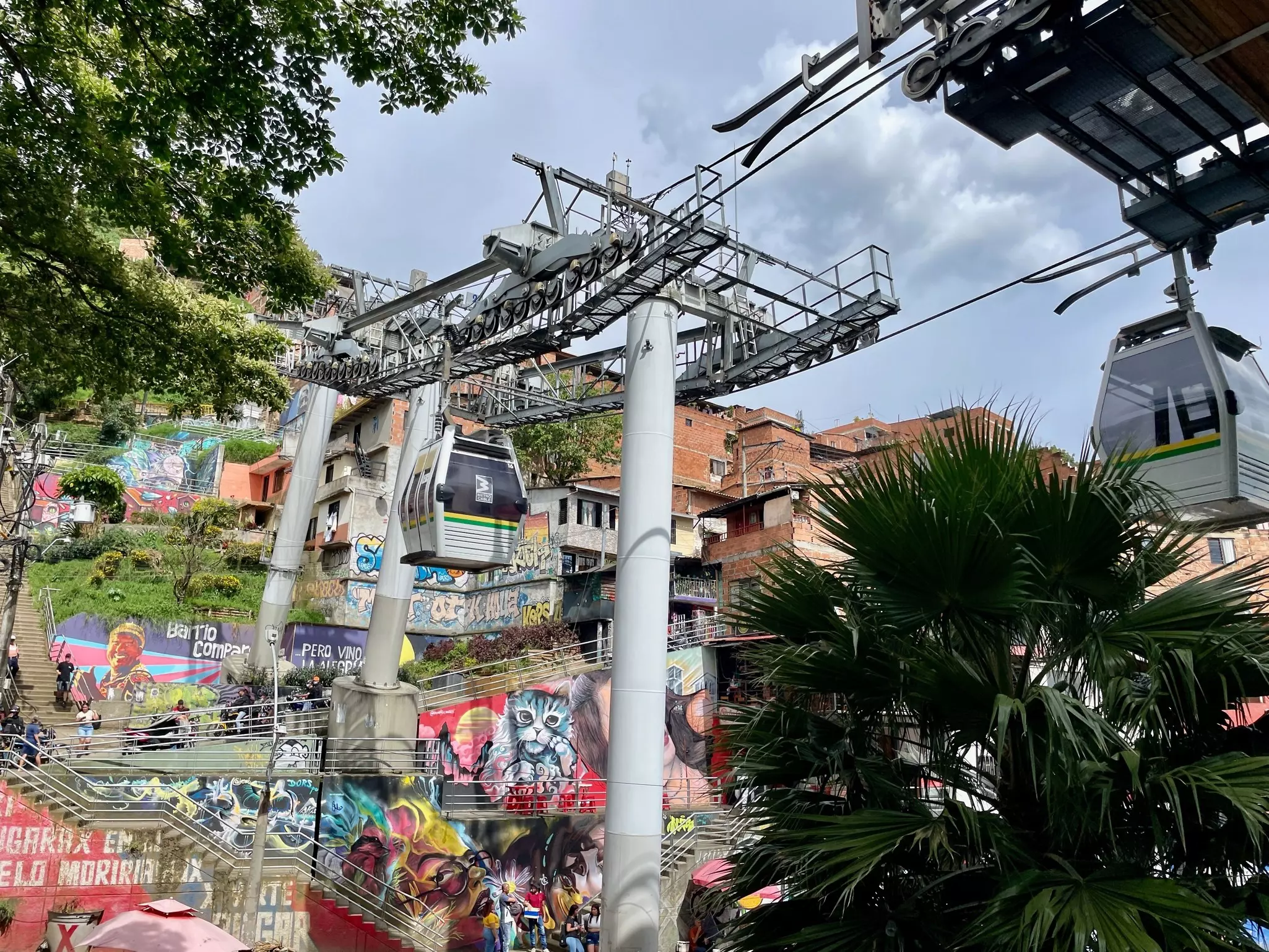 Aerial cable cars making their way past colorful buildings