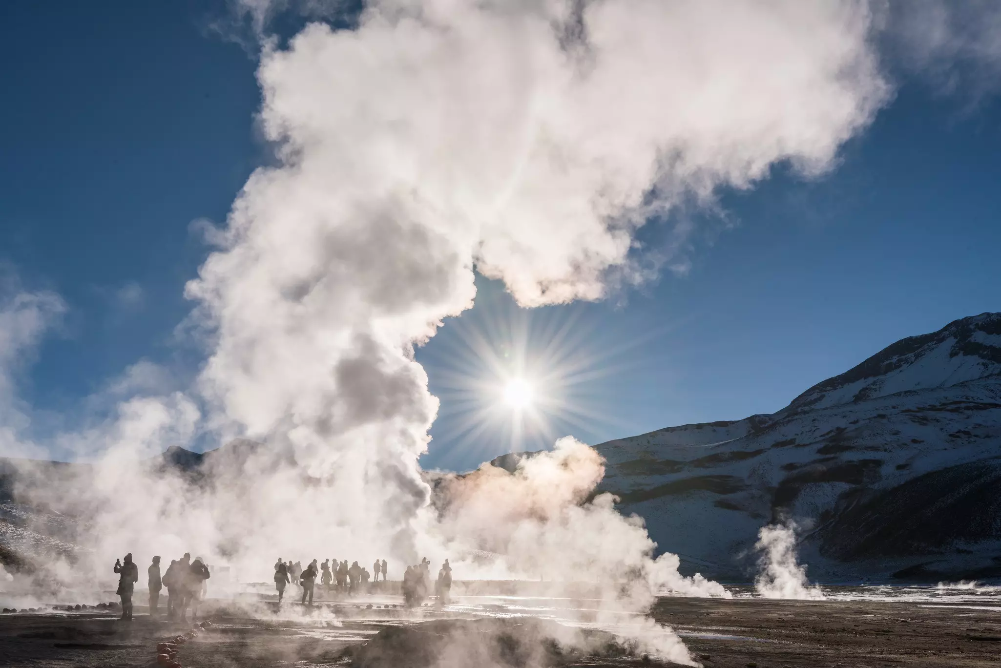 Visitors in steam at El Tatio geysers, Northern Chile