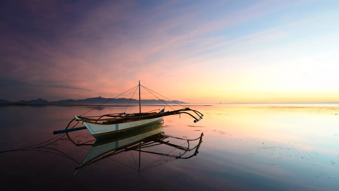 Sunset with moored outrigger.