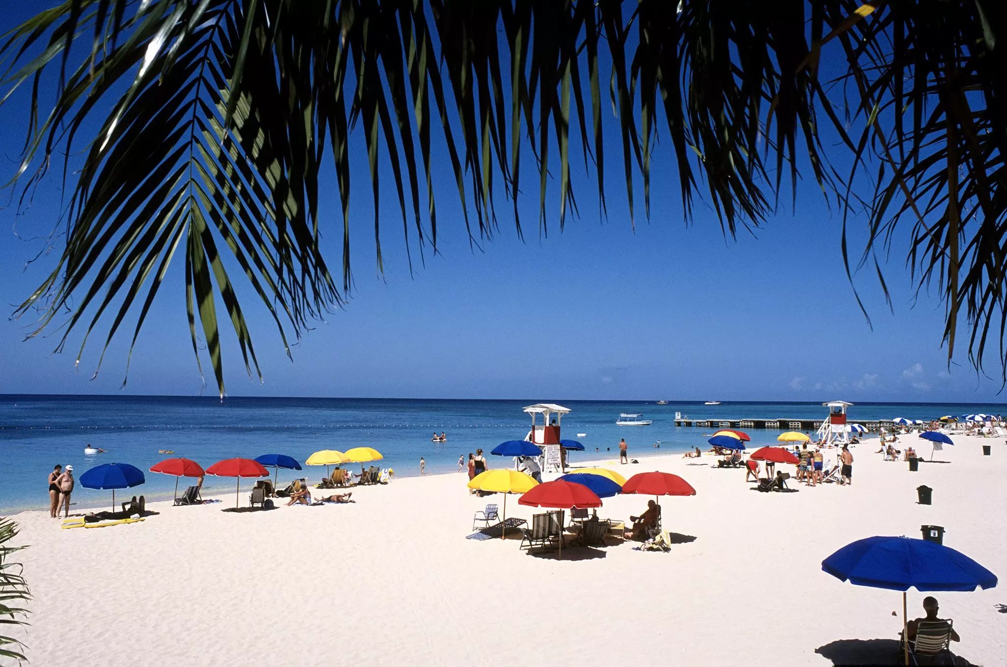 People relaxing at Doctor Cave Beach at Montego Bay in Jamaica.