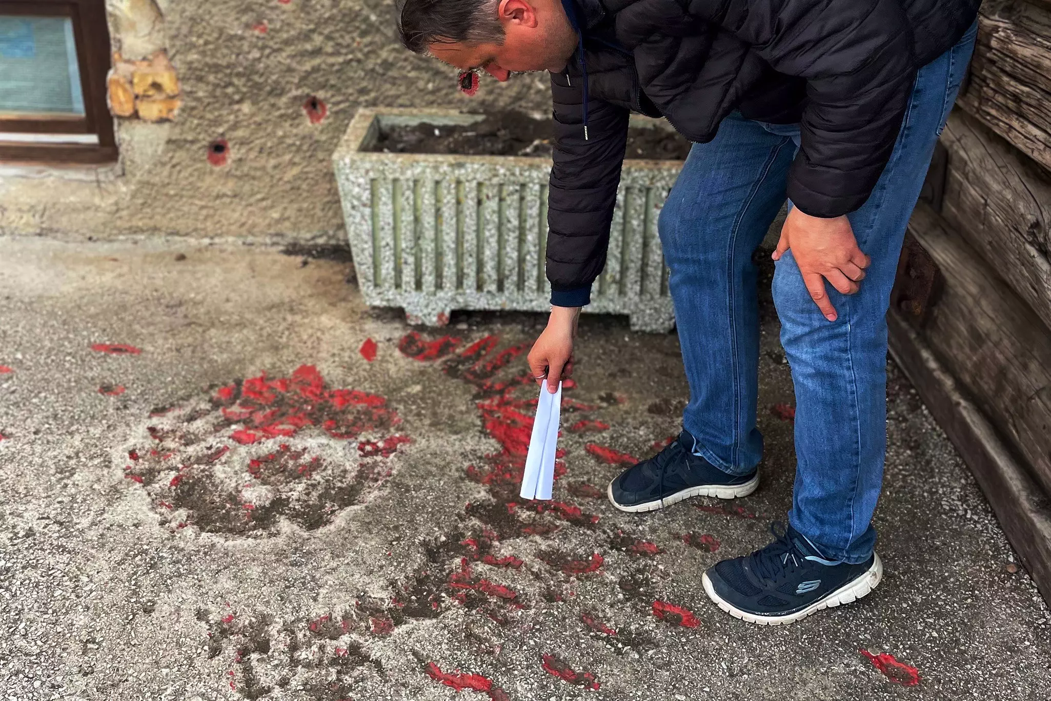 Almir points out the Sarajevo Rose © Robyn Wilson/Lonely Planet