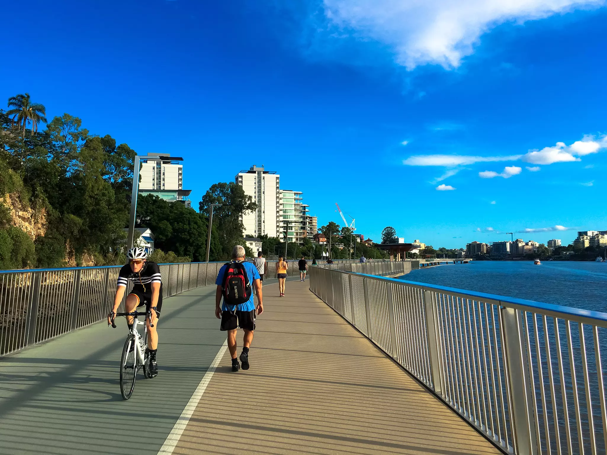 Brisbane Riverwalk with a runner and a cyclist