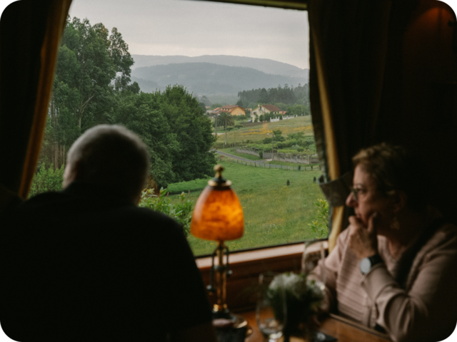 Two people looking out of a train in Spain.