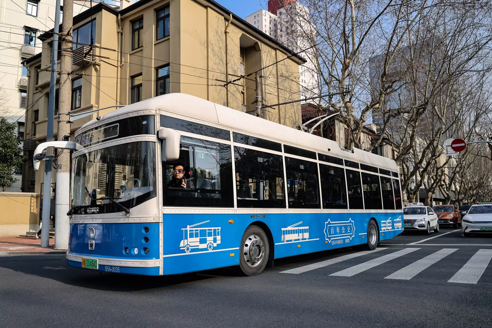 A public bus passes along a road in Shanghai, China.
