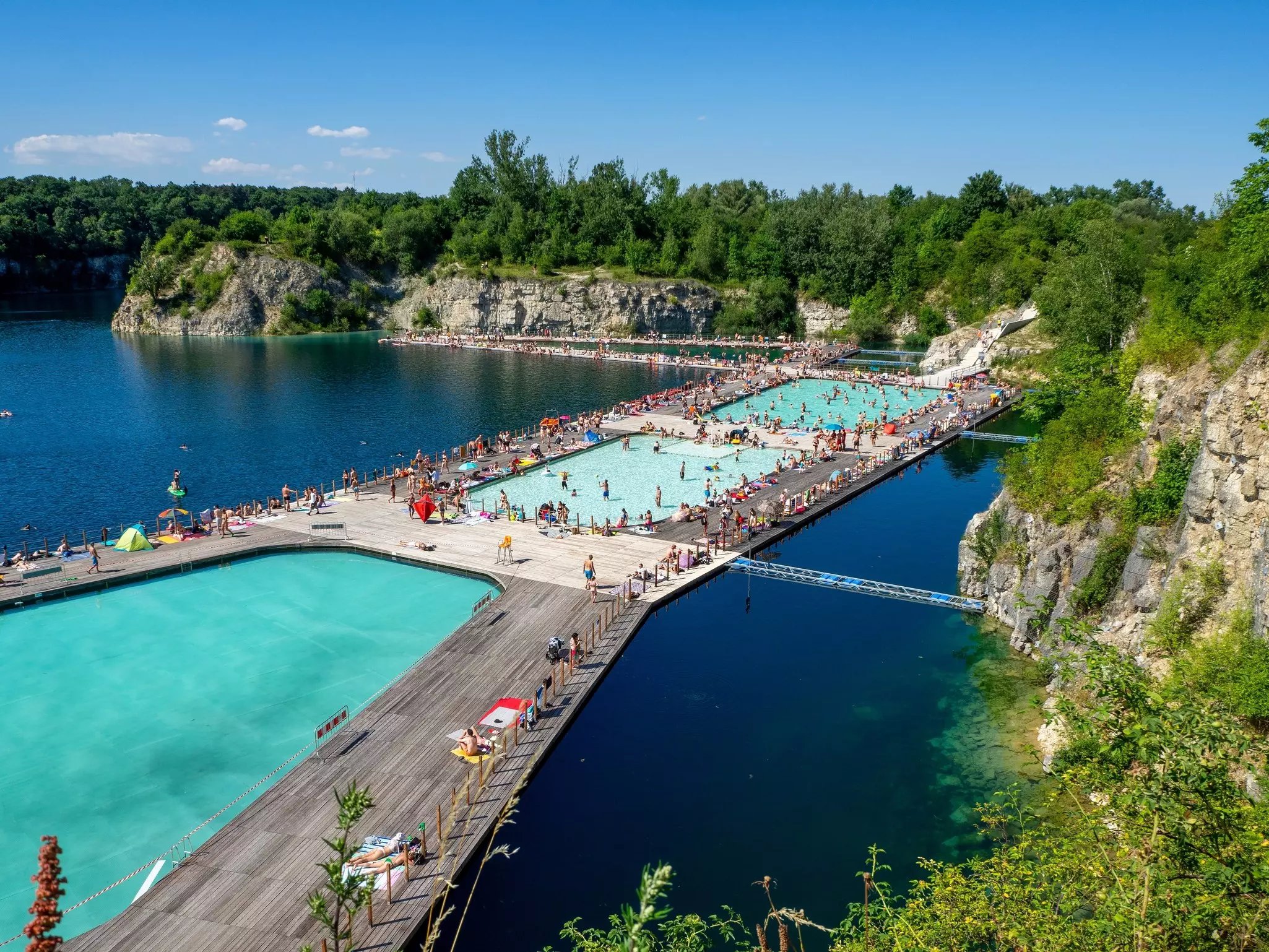 An aerial view of people on a floating pool complex with connected decks.