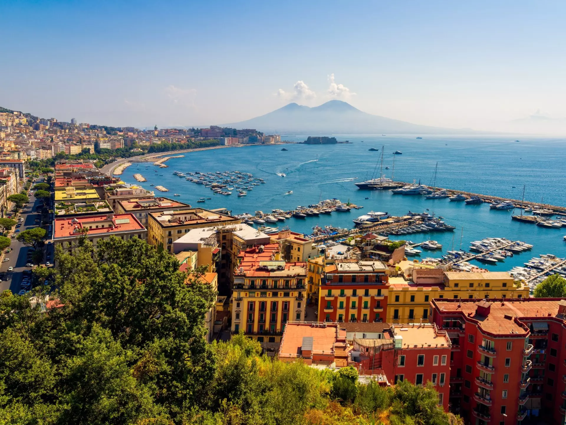 The harbor and Mt Vesuvius in Naples, Italy. Photosbypatrik/Shutterstock