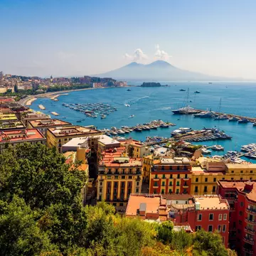 The harbor and Mt Vesuvius in Naples, Italy. Photosbypatrik/Shutterstock