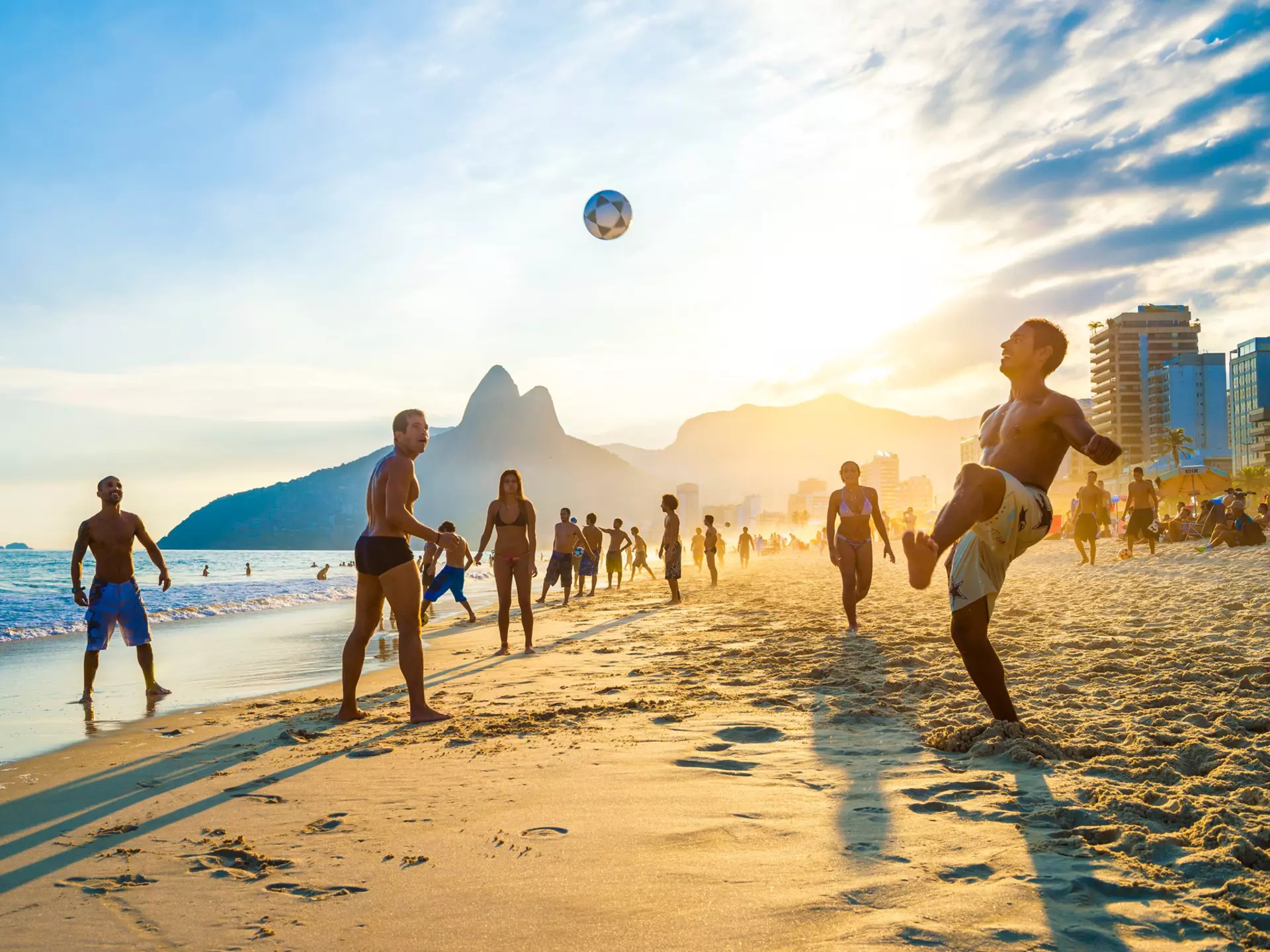 RIO DE JANEIRO - APRIL 01, 2014: Groups of young Brazilians play keepy uppy beach football, or altinho, at sunset on the shore of Ipanema Beach at Posto 9., License Type: media, Download Time: 2025-05-28T09:45:27.000Z, User: lonelyplanetmedia, Editoria...