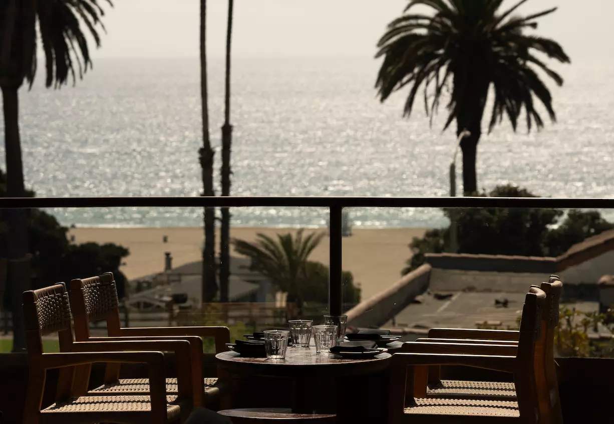 A restaurant table with a view of the ocean