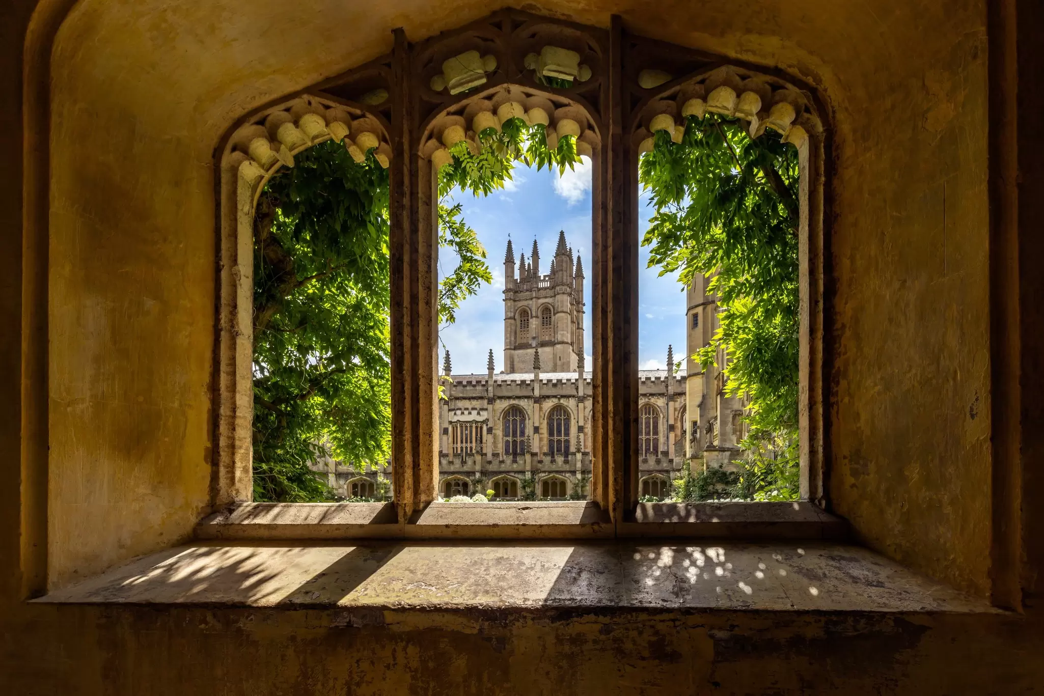 View through a window of Magdalen College in Oxford University on a sunny day.