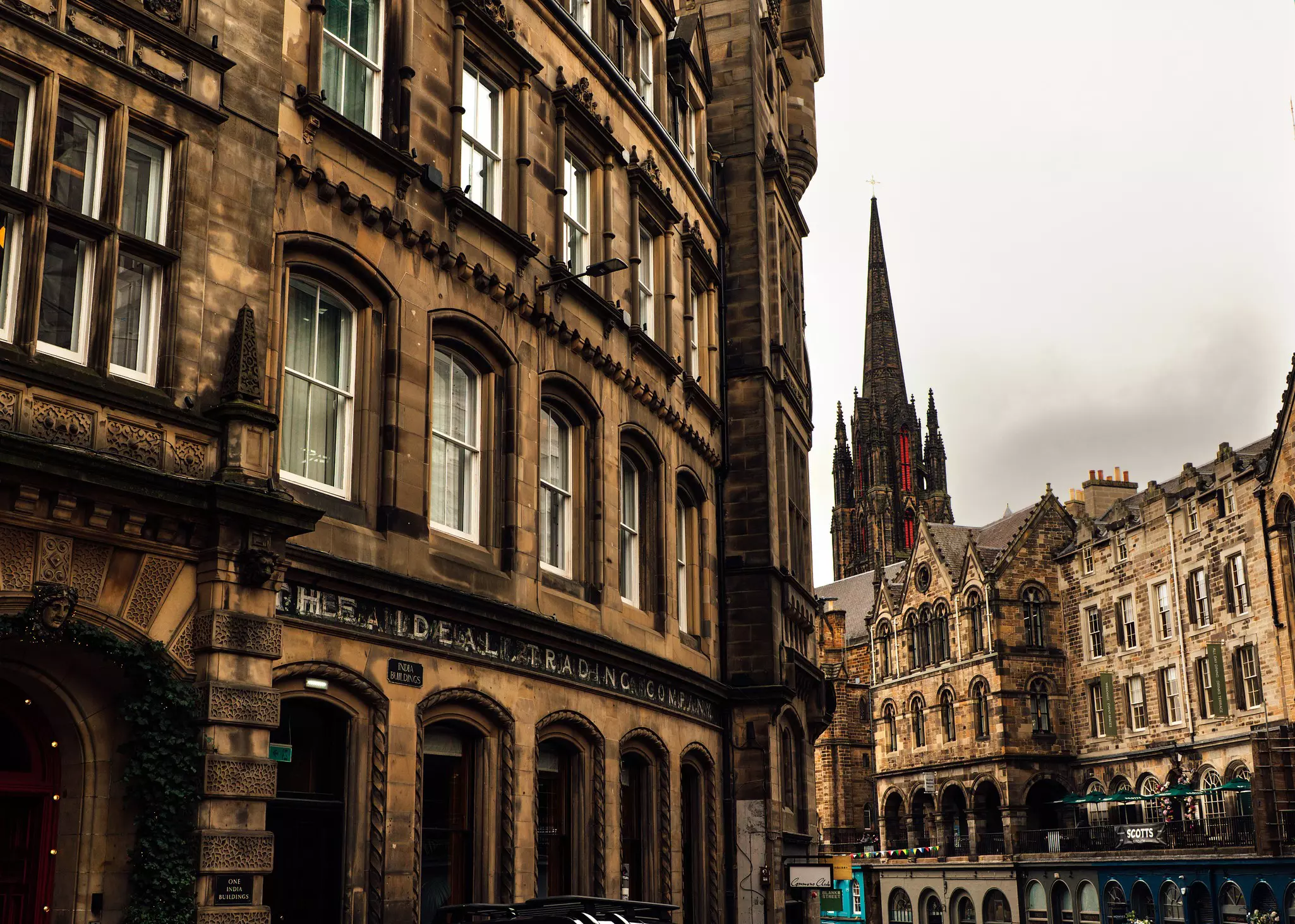 A church spire rises above historic stone buildings.