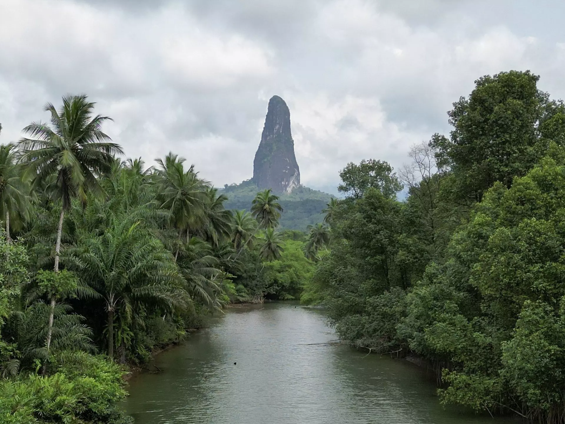 Pico Cão Grande rises over the Rio Caué, São Tomé and Principe.