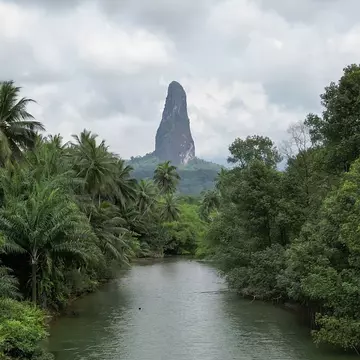 Pico Cão Grande rises over the Rio Caué, São Tomé and Principe.