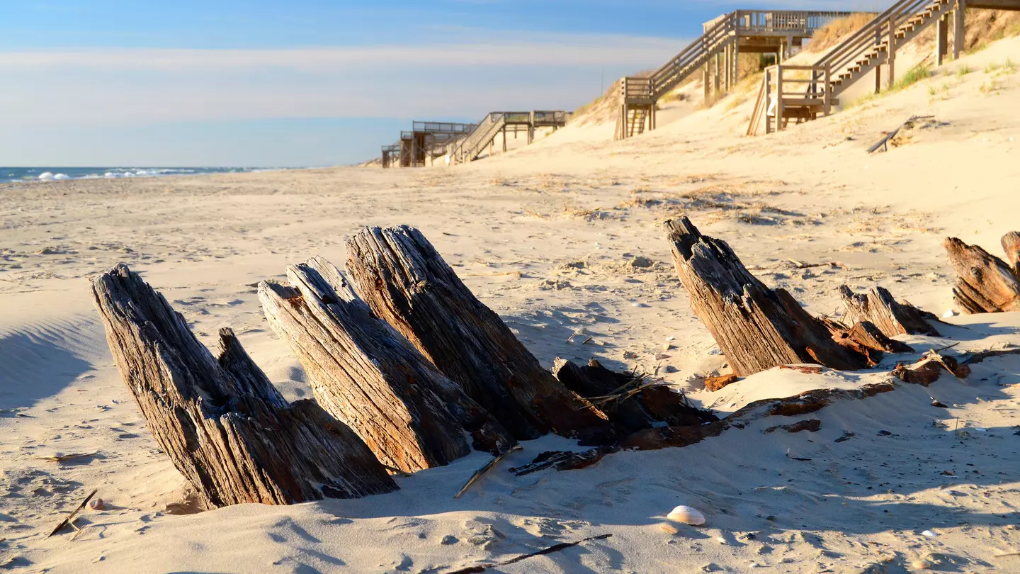 The remains of a historic shipwreck poke through the sands along the Outer Banks of North Carolina
