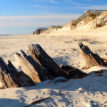 The remains of a historic shipwreck poke through the sands along the Outer Banks of North Carolina