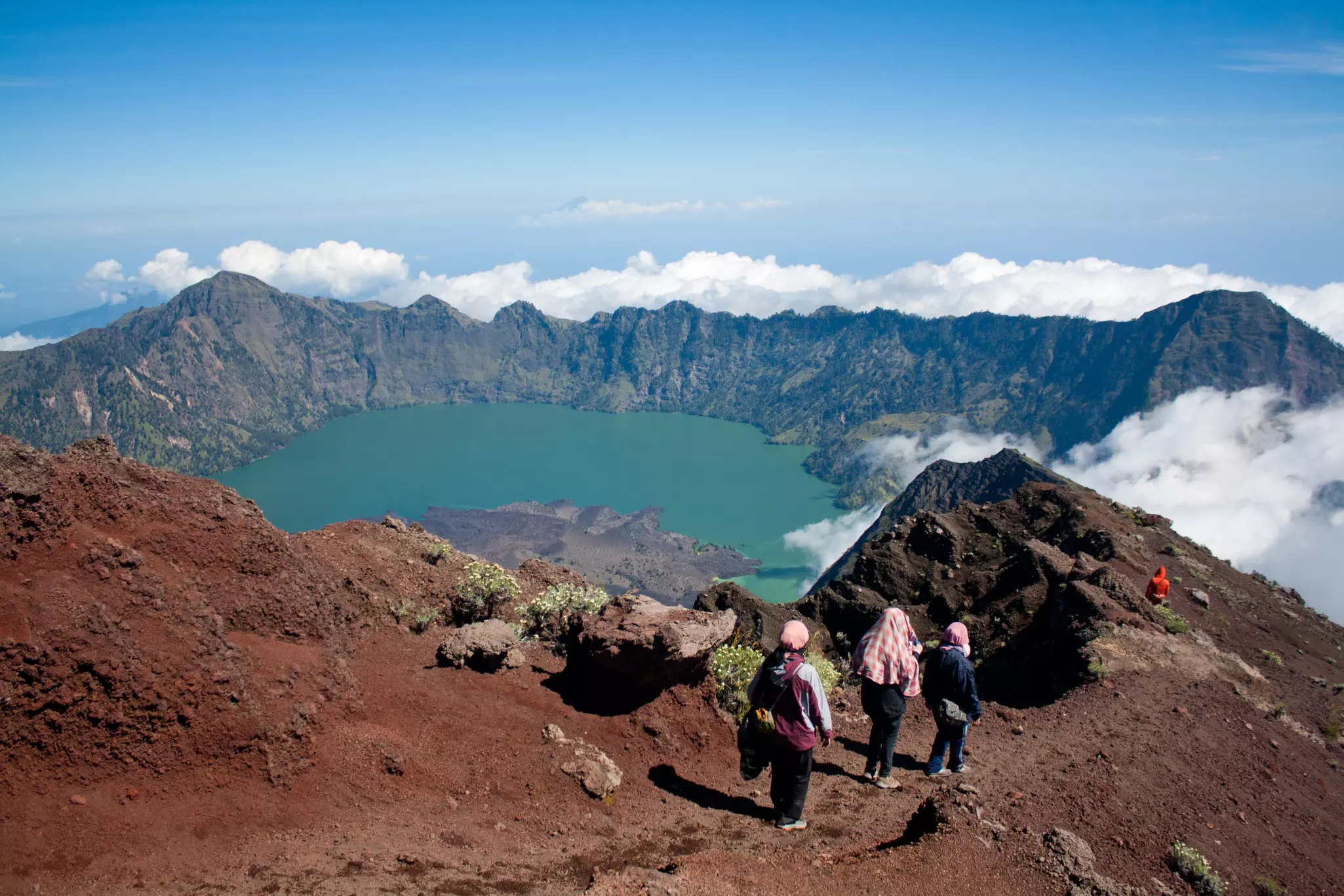 Hikers enjoying the breathtaking views from near the summit of Mt Rinjani, Lombok, Indonesia.