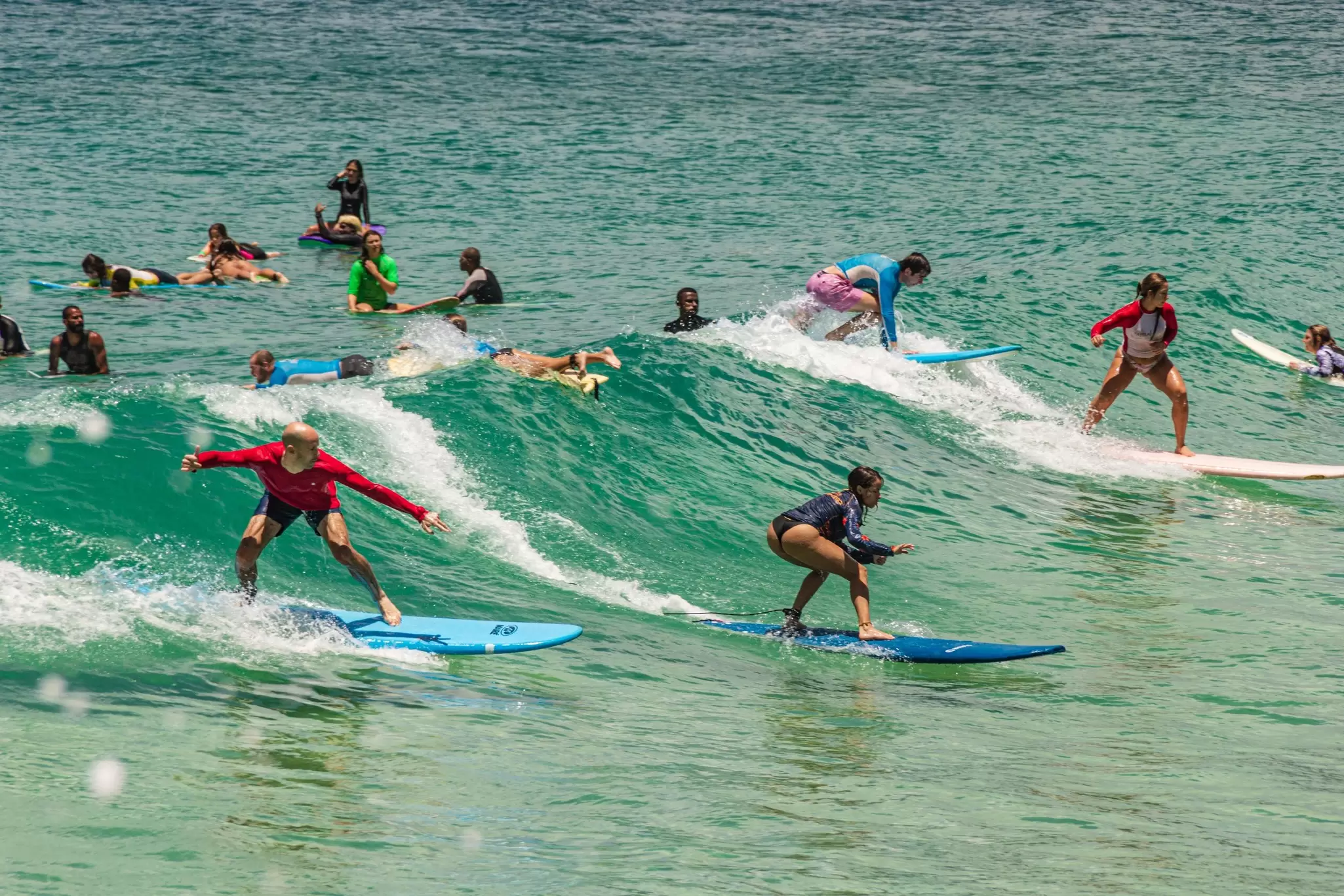 People surfing at Arpoador Beach along the famous Ipanema Beach in Rio de Janeiro, Brazil.