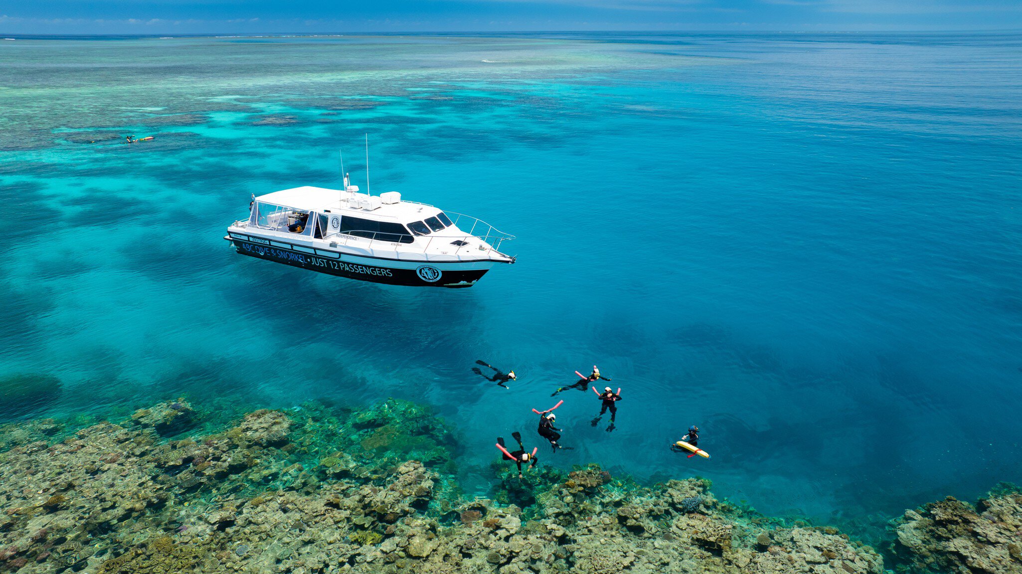 Aerial view of snorkelers  at the ABC Reef Safaris in the Great Barrier Reef, Australia.