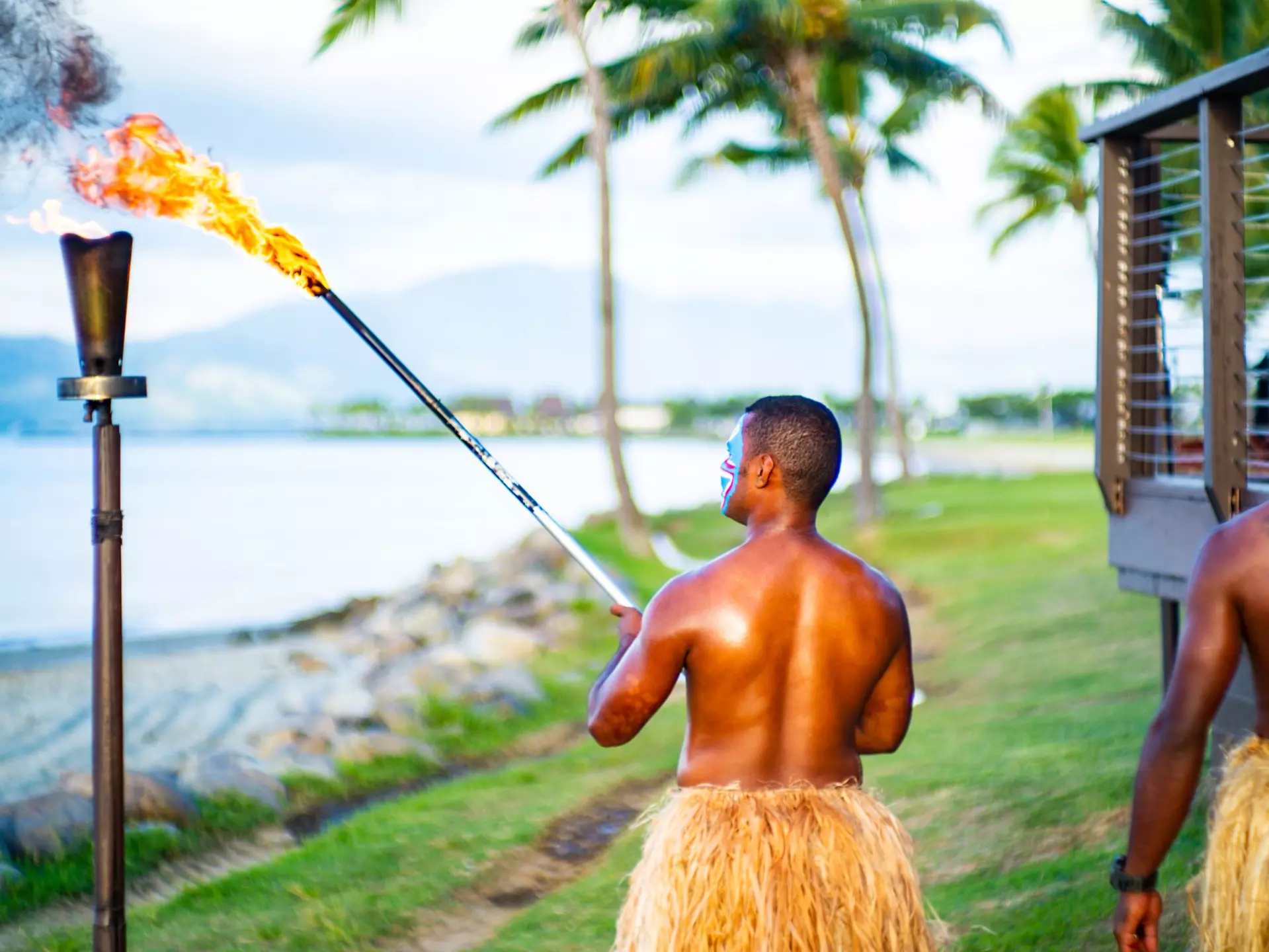Fijian people performing the lighting of the beach torches.