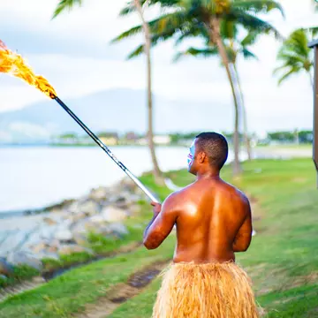 Fijian people performing the lighting of the beach torches.