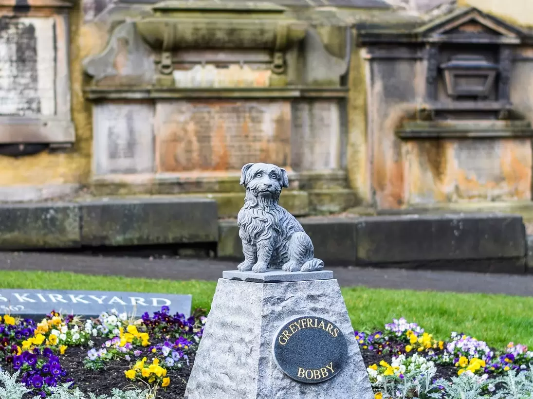The Greyfriars Bobby grave at Greyfriars Kirkyard, honoring the dog that stayed with his master after death in Edinburgh, Scotland.