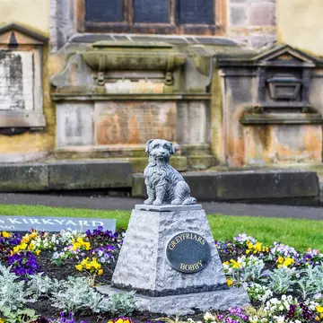 The Greyfriars Bobby grave at Greyfriars Kirkyard, honoring the dog that stayed with his master after death in Edinburgh, Scotland.