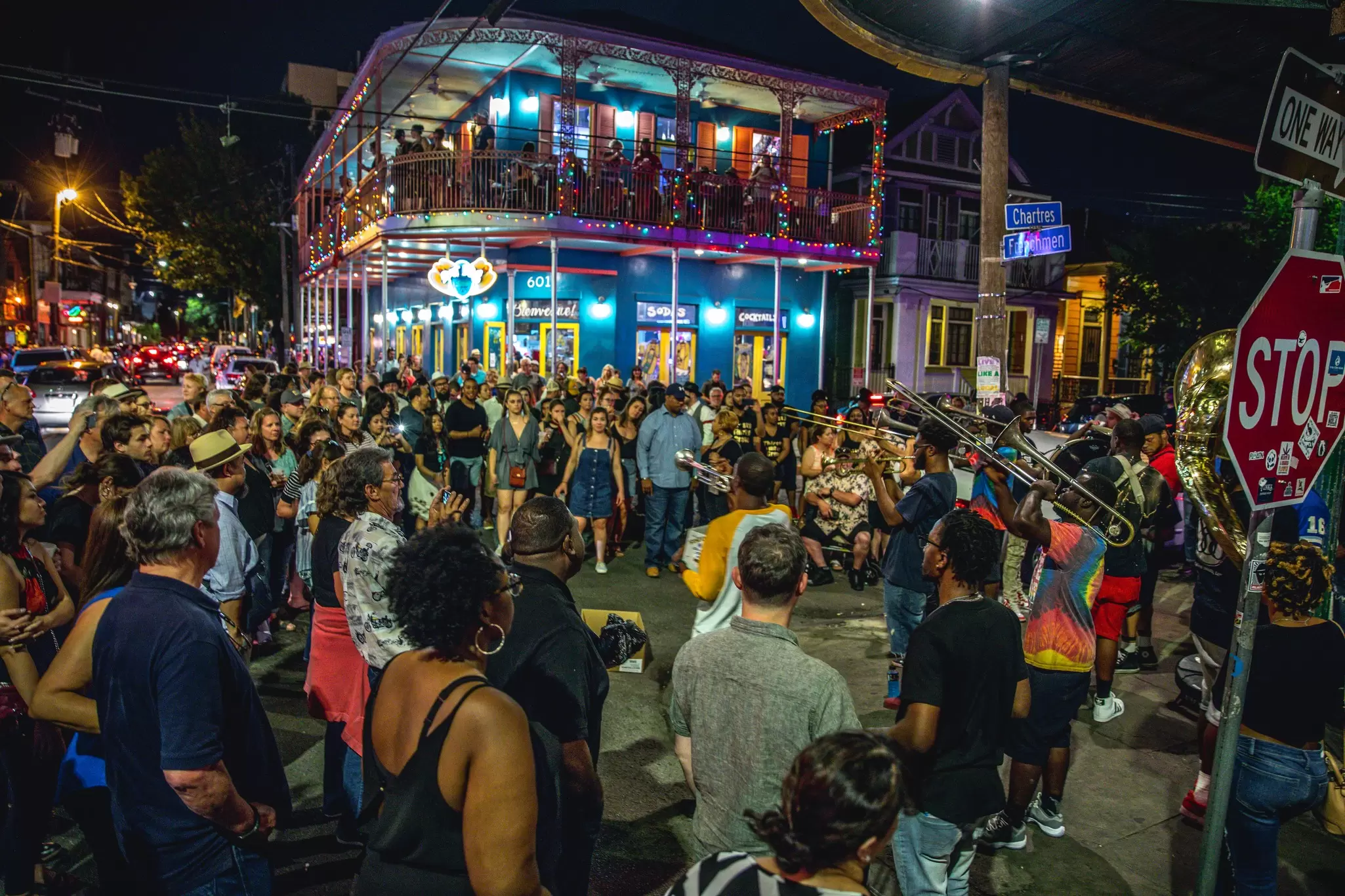 View of a band performing outside 'Dat Dog' on Frenchmen Street in New Orleans, Louisiana, at night.