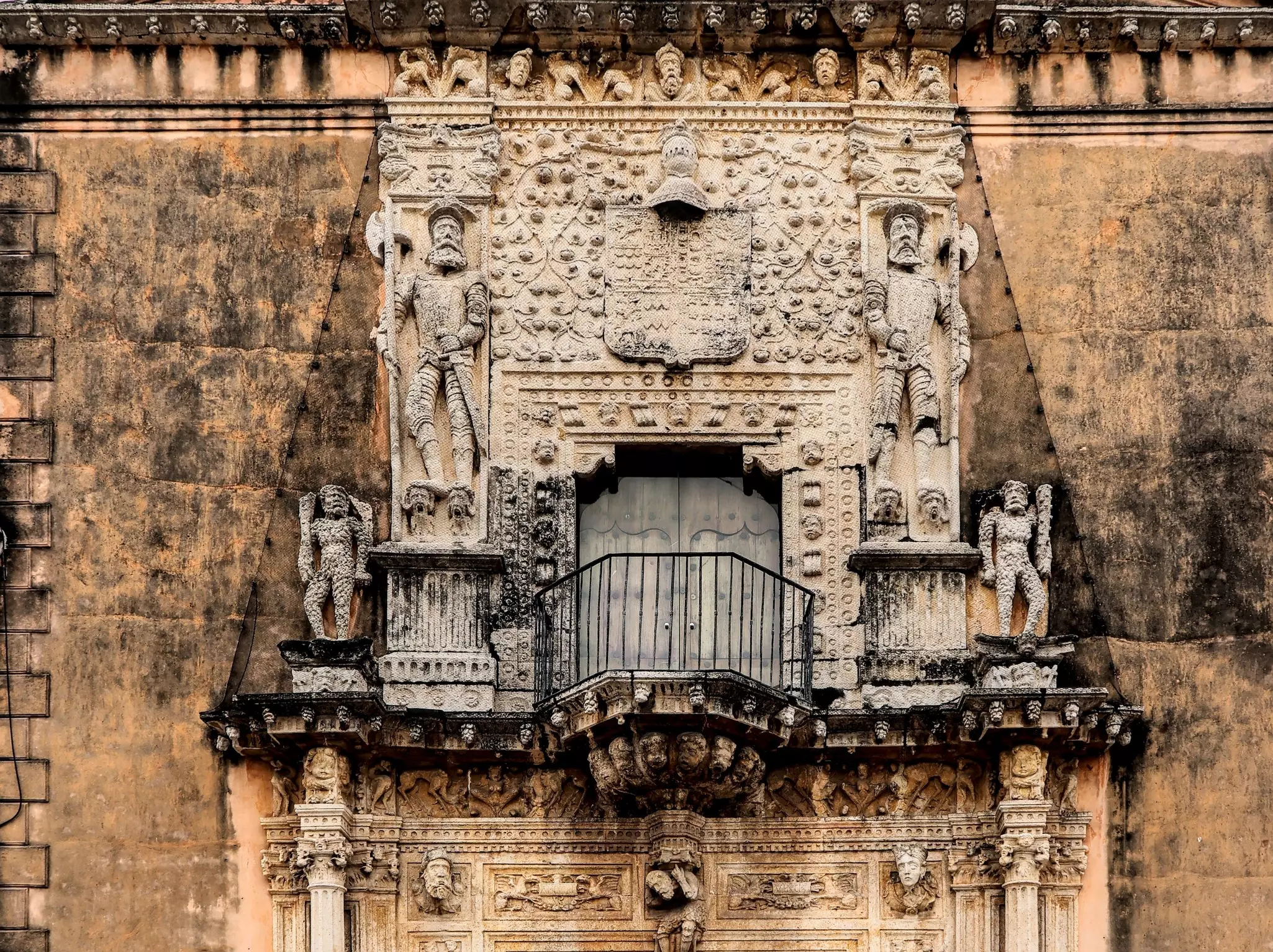 Old edifice with detailed spanish colonial carvings in Merida, Mexico