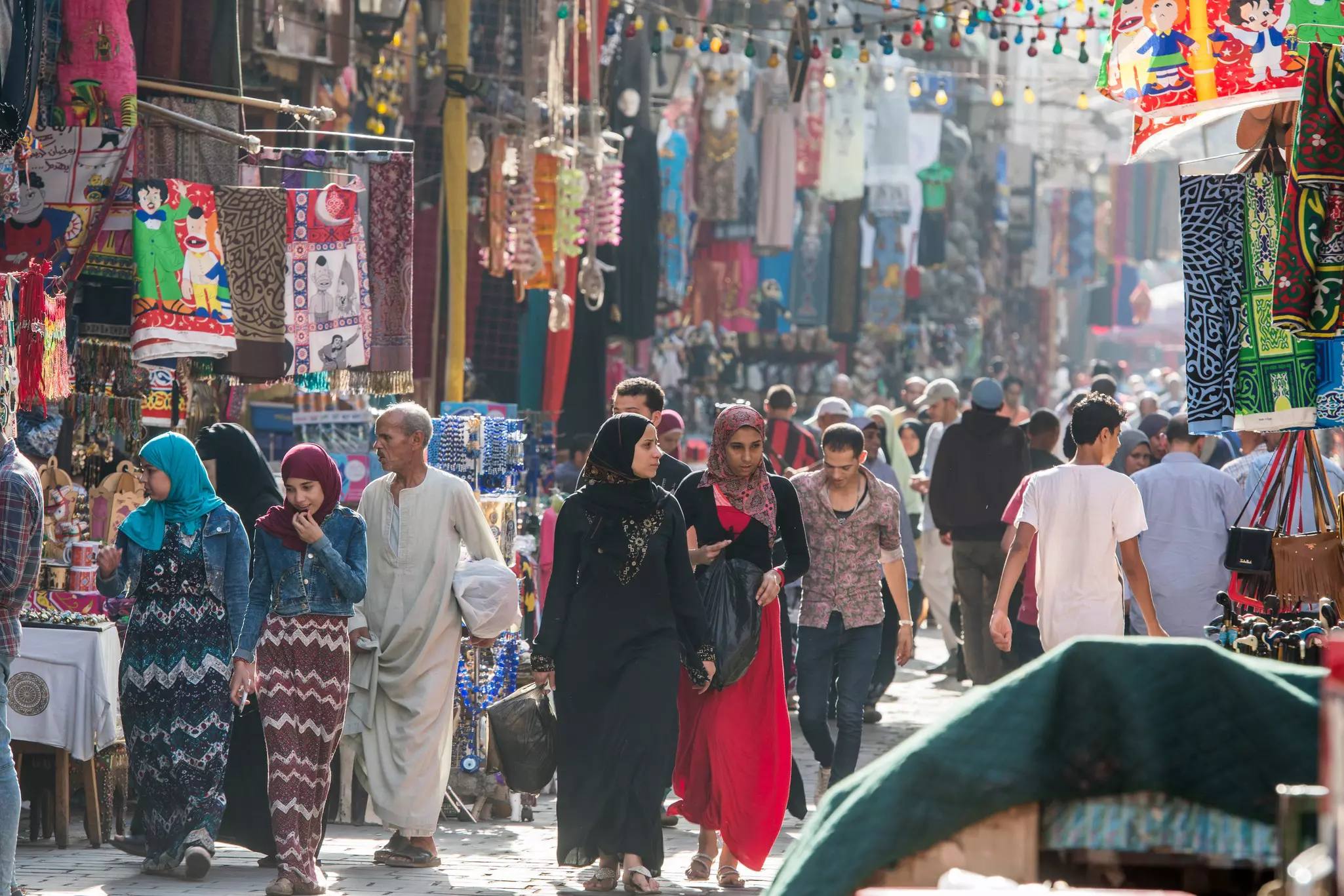 People walking through shops at an outdoor bazaar in Khan el-Khalili in Cairo.