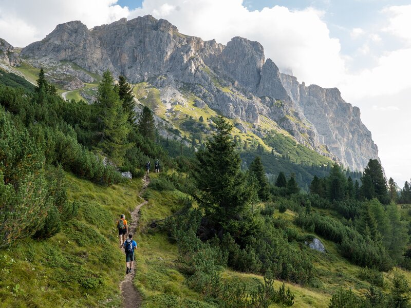 Hikers follow a mountain trail near Cortina d'Ampezzo in the Dolomites.